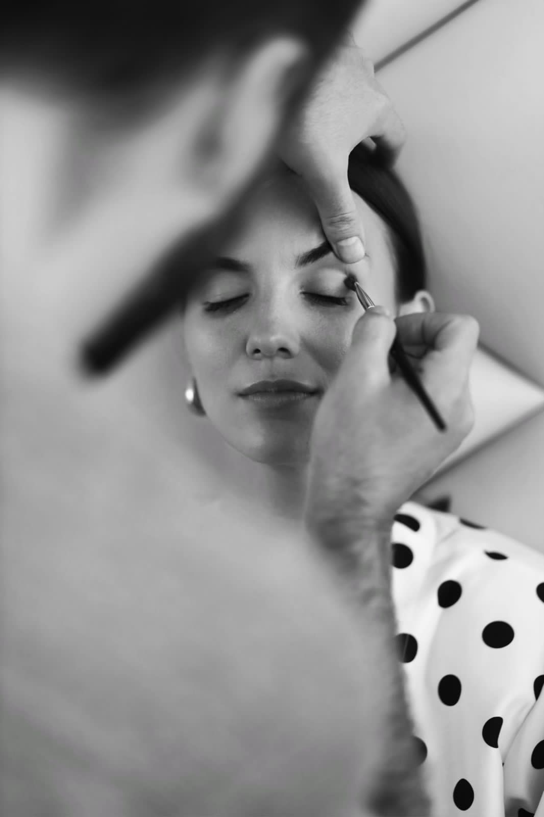 Black-and-white photograph of professional makeup preparation